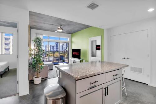 a kitchen with a counter top and a living room at Centric 2BR In HEART of DTPHX Free Garage Parking in Phoenix