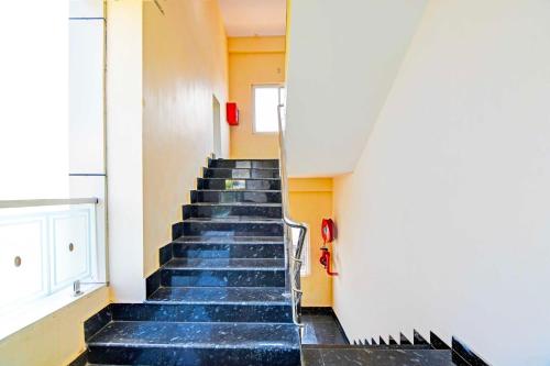 a staircase in a building with blue steps at Townhouse Oak Dwarakanagar Port Stadium in Maddilapālem
