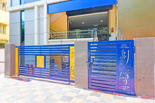 a blue gate in front of a building at Townhouse Oak Dwarakanagar Port Stadium in Maddilapālem