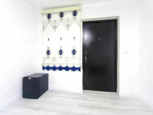 a black door in a white room with a wall at Meymandos in Tossor