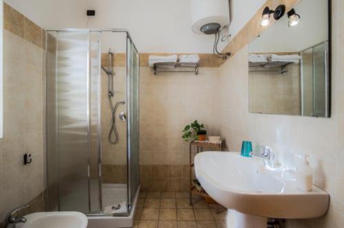 a bathroom with a sink and a shower at S'Attobiu Guest Rooms in Teulada