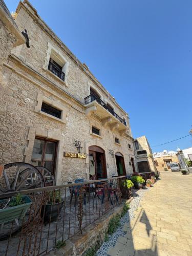 a brick building with a fence in front of it at kyrenia palace boutique hotel in Kérynia