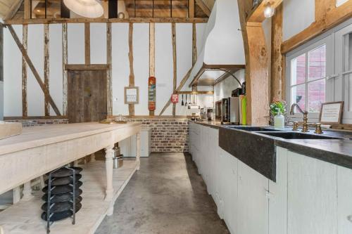 a large kitchen with a counter and a sink at Ter Winterbeke op een steenworp van Poperinge in Poperinge