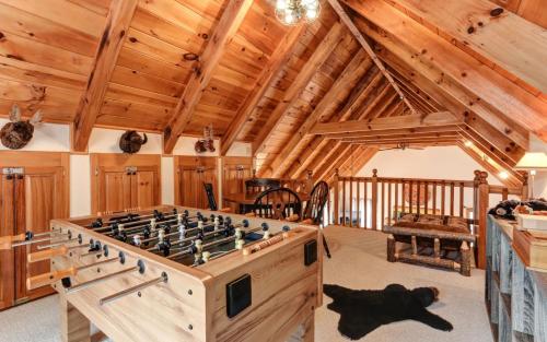 a room with a large wooden foosball table at Wanderers Den - Peaceful mountain views Wifi and homey comforts in Jasper