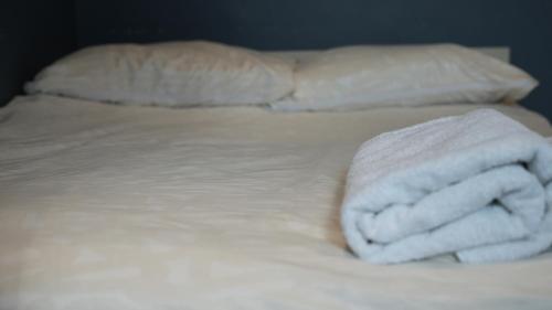 a bed with white towels on top of it at Apartment & Rooms in London in Croydon