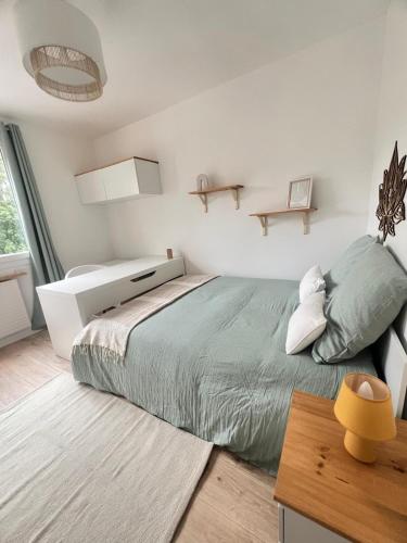 En eller flere senge i et værelse på Appartement 6 chambres