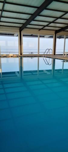 a pool of water with a bench in the middle at Hotel San Antonio in Podstrana