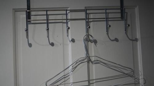 a closet with a glass door with a rack at Apartment & Rooms in London in Croydon