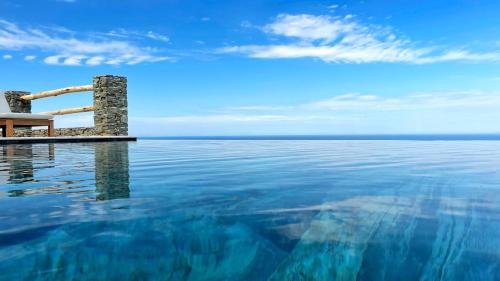 a swimming pool with a view of the ocean at Sigma Residences Boutique Hotel in Exámbela