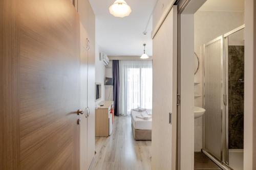 a bathroom with a sink and a toilet in a room at Bayram Hotel in Çeşme