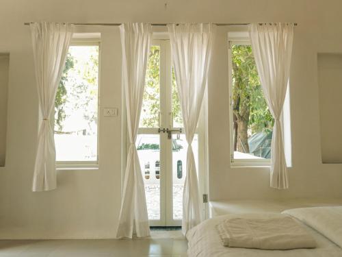 a bedroom with a bed and a large window at Mama killa- Villa Stays in Pushkar