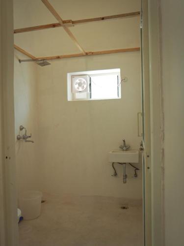 a bathroom with a sink and a window at Mama killa- Villa Stays in Pushkar