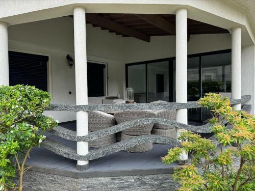 a bench on the porch of a house at Tout confort 6 personnes - Proche de Disney in Claye-Souilly