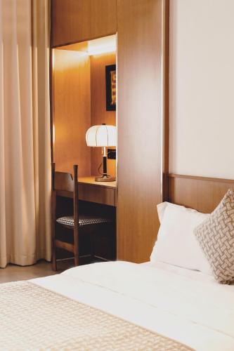 a bedroom with a bed and a desk with a lamp at Tuji Lane and Fanghe Homestay (West Street Kaiyuan Temple Branch) in Quanzhou