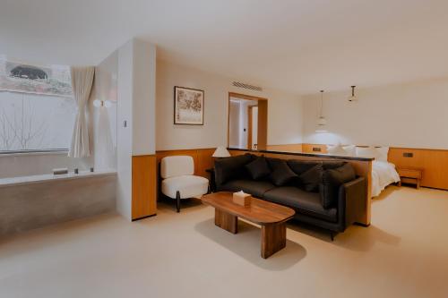 a living room with a couch and a table at Tuji Lane and Fanghe Homestay (West Street Kaiyuan Temple Branch) in Quanzhou