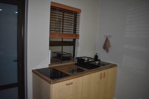 a kitchen with a stove and a counter top at Pualani Self Catering in Strand