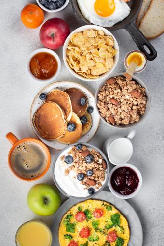 a table with many plates of breakfast food on it at Radisson Blu Hotel Ranchi in Rānchī