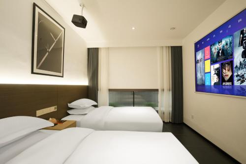 Voodi või voodid majutusasutuse Time Wharf Hotel - Jiefangbei Shibati Branch toas