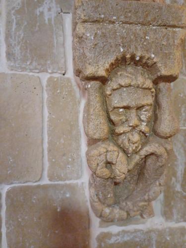 a stone statue of a man on a brick wall at Ebner Pince - Panzió in Turbékpuszta