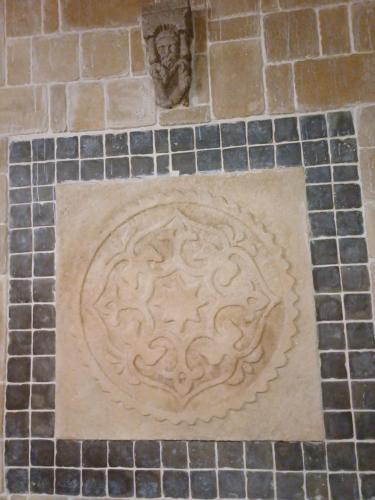 a stone relief on the floor of a building at Ebner Pince - Panzió in Turbékpuszta