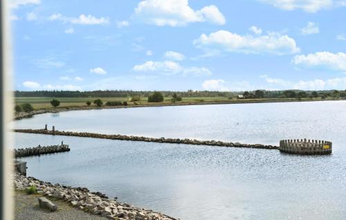 a large body of water with a rock retaining wall at Gorgeous Apartment In Nykøbing Sj in Nykøbing Sjælland