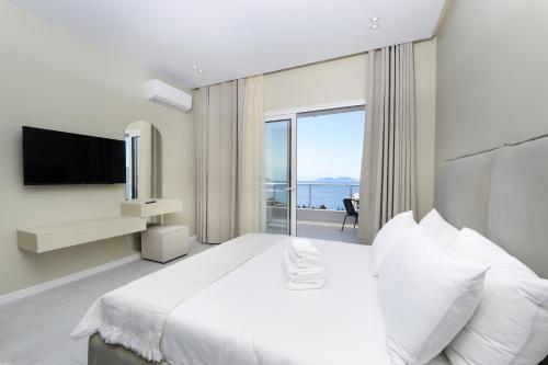 a bedroom with a large bed and a large window at Villa Christianna Free Parking in Vlorë
