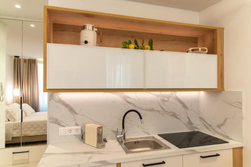 a kitchen with a sink and a counter top at Sims Suites in Corfu
