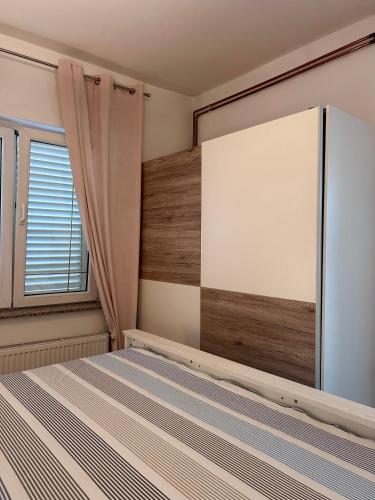 a bedroom with a bed and a large window at Apartment Laura in Senj