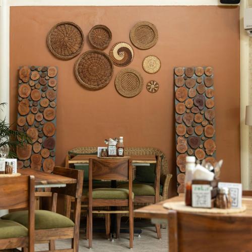 a dining room with wooden tables and plates on the wall at Hotel Kamal Palace in Jalandhar