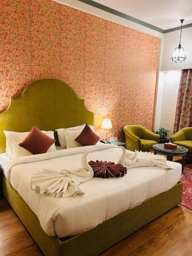 a bedroom with a large bed in a room at Hotel Kamal Palace in Jalandhar
