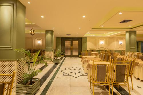 a restaurant with tables and chairs in a room at Hotel Kamal Palace in Jalandhar