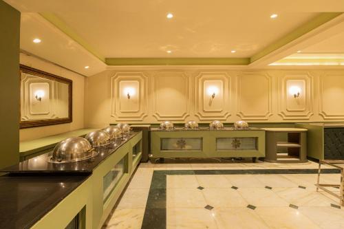 a large kitchen with silver dishes on a counter at Hotel Kamal Palace in Jalandhar