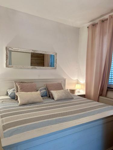 a bedroom with a large bed with two pillows at Apartment Laura in Senj