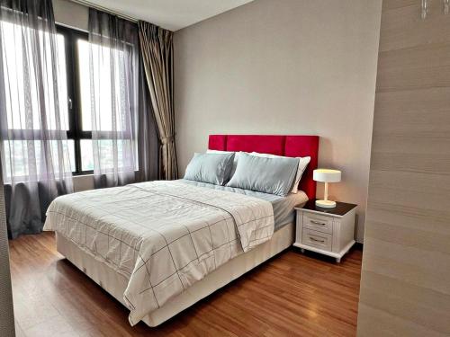 a bedroom with a large bed with a red headboard at HYDE3 i-City ITQAN Premium Home - 8pax, Netflix, Parking in Shah Alam