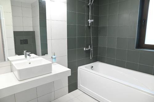 a bathroom with a tub and a sink and a bath tub at Hotel Etar in Gabrovo