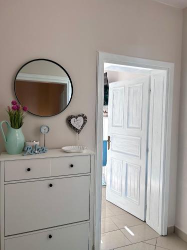 a bathroom with a white dresser and a mirror at Apartment Laura in Senj