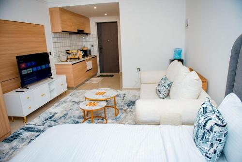 a living room with a white bed and a couch at Tulia Haven in Ruaka