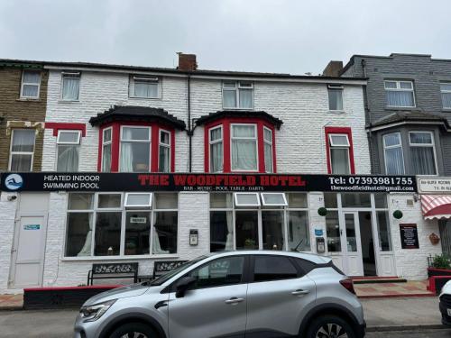 a silver car parked in front of a building at The Woodfield Hotel , Indoor Heated swimming pool, Spacious lounge and Bar in Blackpool