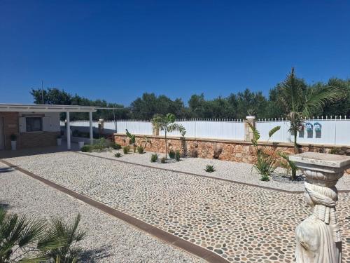 a garden with a stone pathway and a fence at Villa Dadis in Chania