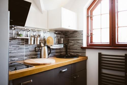 a kitchen with a sink and a stove top oven at Orange Pokoje in Karpacz