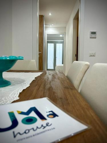 a wooden table with a sign on top of it at Joma House in Càbras