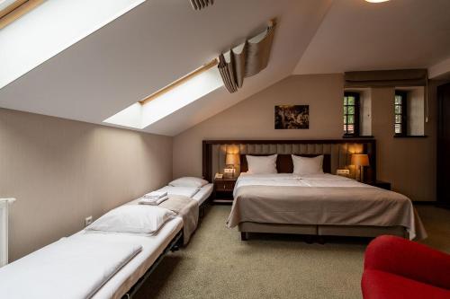 a bedroom with two beds and a skylight at Grand Sal in Wieliczka