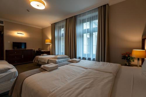 a hotel room with two beds and a window at Grand Sal in Wieliczka