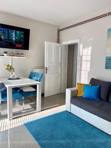 a living room with a white table and a couch at Apartment Laura in Senj