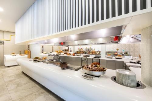a large kitchen with a counter with food on it at Riviera Zen Hotel Adult Only in Alanya