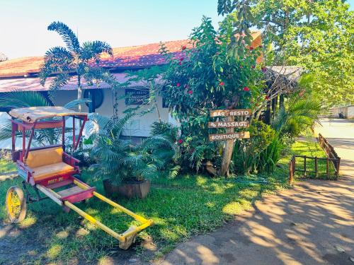 a red cart sitting in front of a house at A casa di Giorgia lodge Nosy be Andilana in Nosy Be