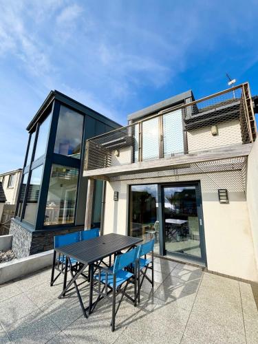 a table and chairs on the patio of a house at Luxury Coastal Getaway in Portstewart