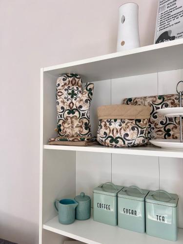 a shelf with cups and other items on it at Apartment Laura in Senj