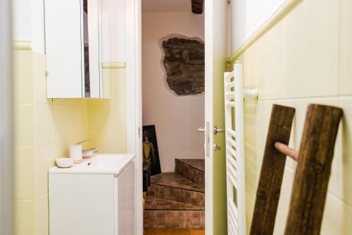 a bathroom with a staircase and a door to a room at Hurban Apartments La Casa dei Fiori in Trieste