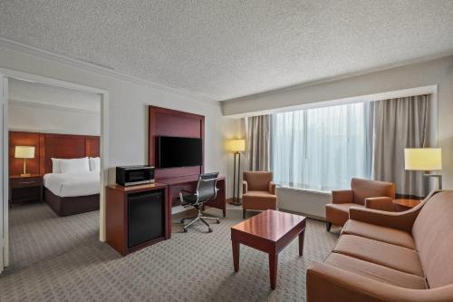 a hotel room with a bed and a living room at Comfort Inn By the Bay in San Francisco